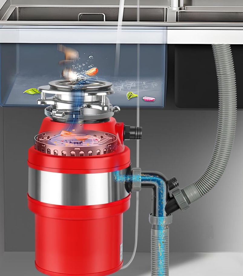 recursos-extras-triturador-de-alimentos Diagrama em corte de um triturador de alimentos (corpo vermelho) instalado sob a pia, ilustrando o fluxo de água e resíduos pela tubulação e câmara de trituração
