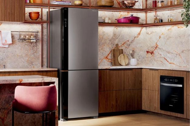 Geladeira inverse inox em cozinha planejada moderna com armários de madeira e eletrodomésticos embutidos